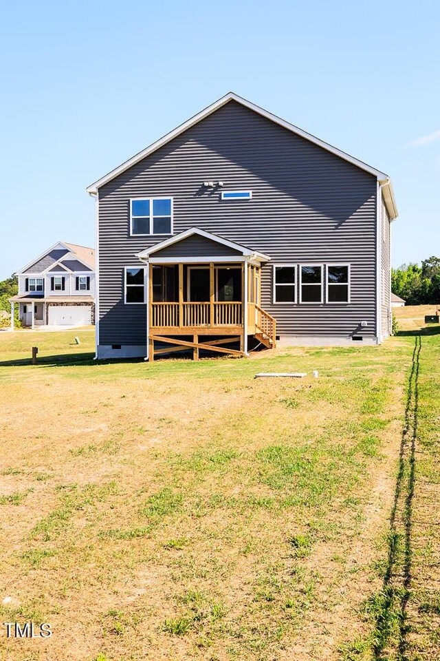 592 Barbour Farm Ln, Four Oaks, NC 27524 - back of property featuring a lawn, a wooden deck, and crawl space