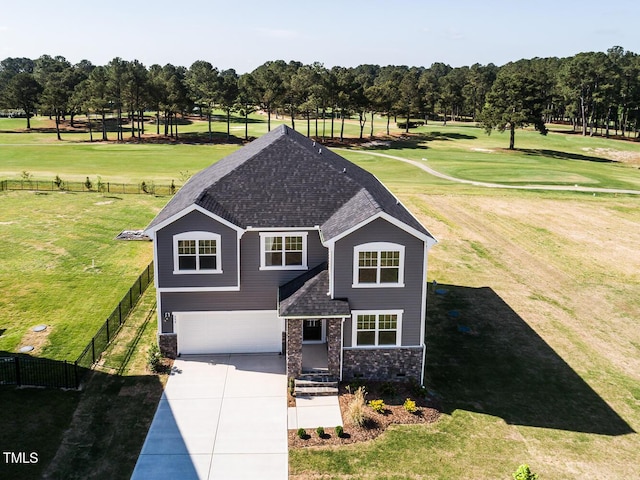 592 Barbour Farm Ln, Four Oaks, NC 27524 - traditional home featuring an attached garage, concrete driveway, view of scattered trees, view of golf course, and a shingled roof
