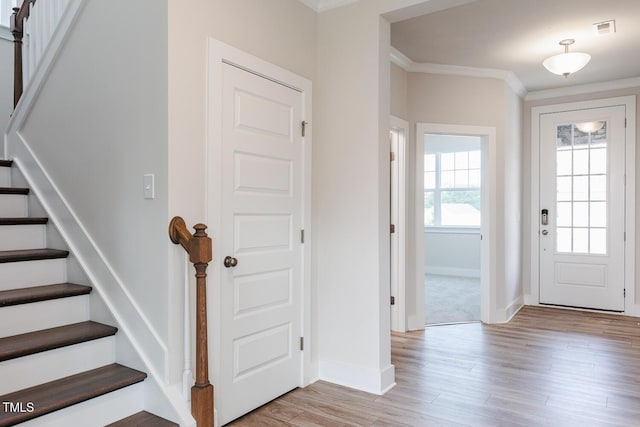 592 Barbour Farm Ln, Four Oaks, NC 27524 - foyer featuring stairs, ornamental molding, and light wood-style floors