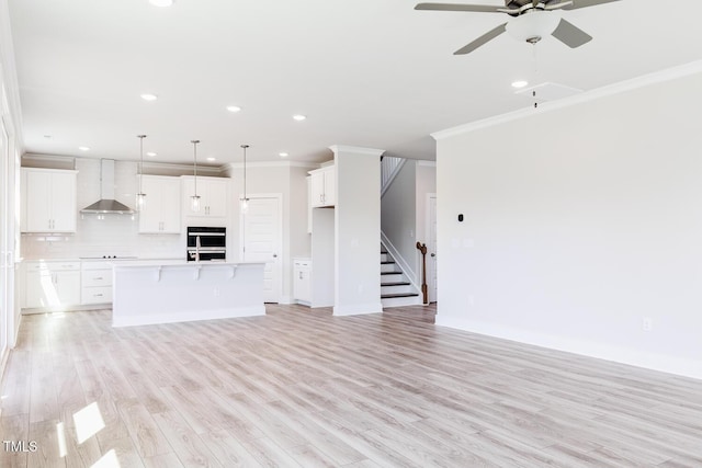 592 Barbour Farm Ln, Four Oaks, NC 27524 - unfurnished living room with ornamental molding, a ceiling fan, light wood-type flooring, recessed lighting, and stairs