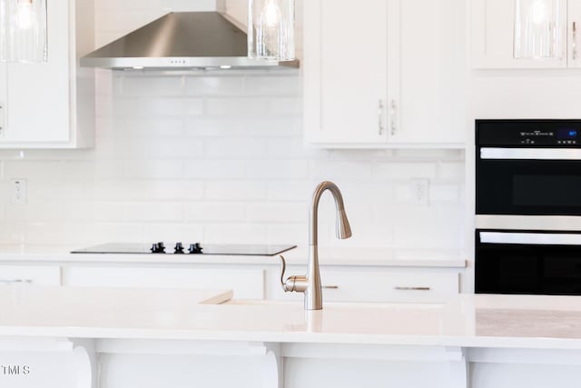 592 Barbour Farm Ln, Four Oaks, NC 27524 - kitchen featuring wall chimney exhaust hood, white cabinetry, tasteful backsplash, and light countertops