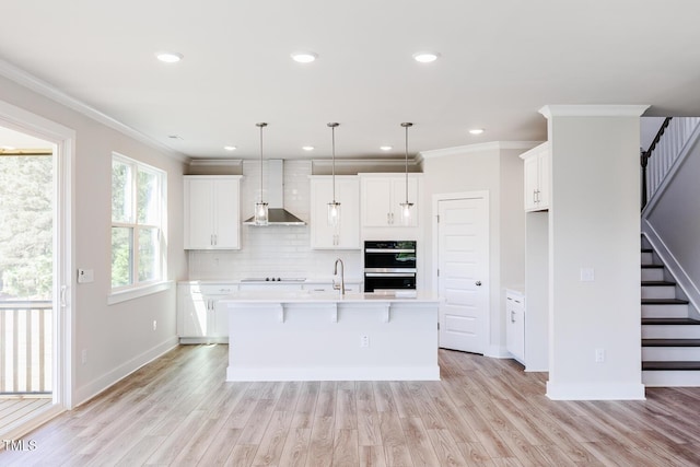 592 Barbour Farm Ln, Four Oaks, NC 27524 - kitchen featuring wall chimney range hood, light countertops, stainless steel double oven, black electric stovetop, and backsplash