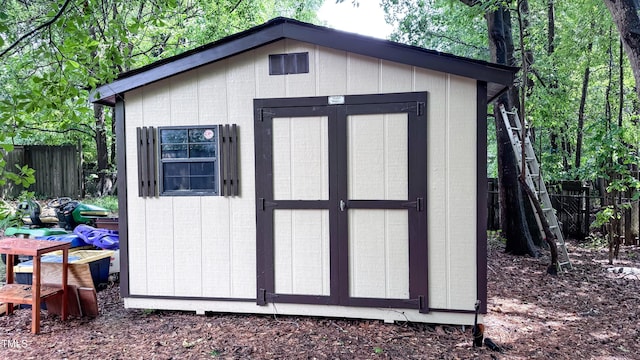 view of shed with fence
