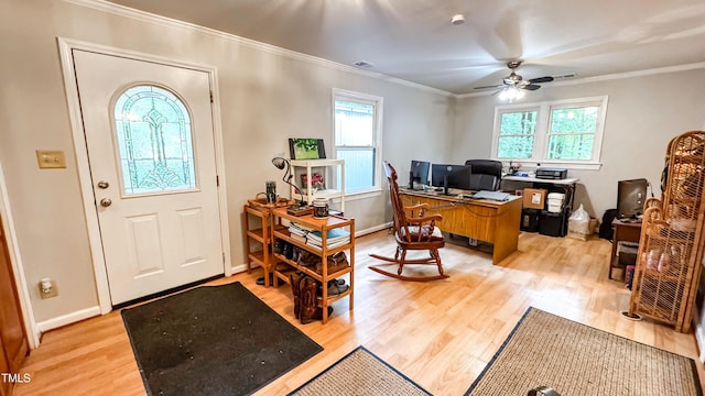 office featuring healthy amount of natural light, light wood-type flooring, ornamental molding, and ceiling fan