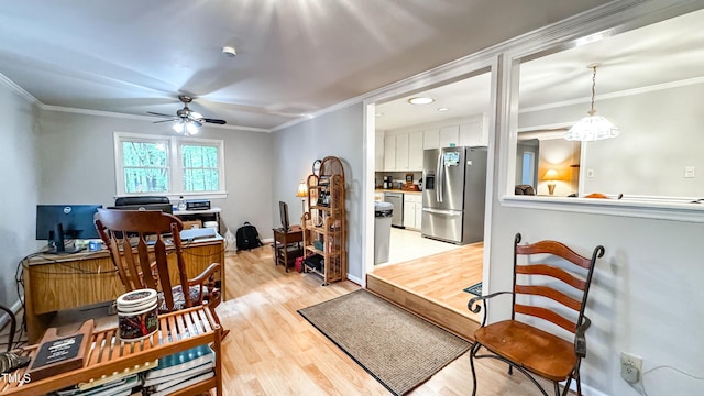 living room featuring light wood-type flooring, ceiling fan, crown molding, and an office area