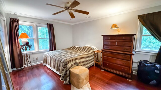 bedroom featuring wood finished floors, ornamental molding, ceiling fan, and baseboards