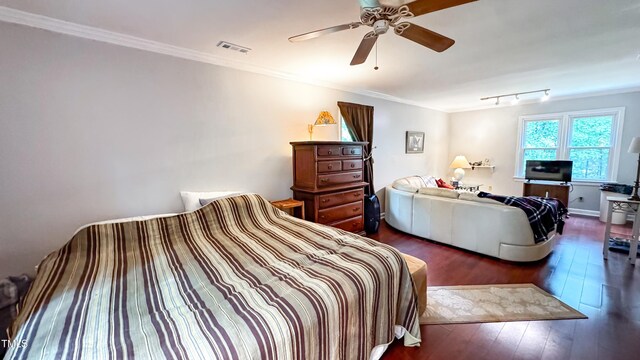 bedroom featuring wood-type flooring, crown molding, and a ceiling fan