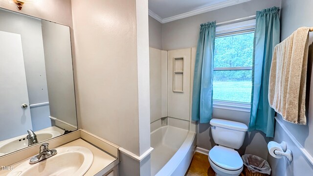 full bath featuring plenty of natural light, crown molding, toilet, vanity, and bathtub / shower combination