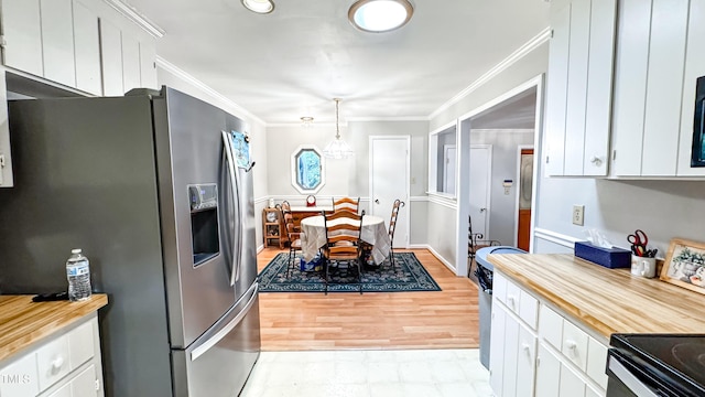 kitchen featuring stainless steel refrigerator with ice dispenser, light countertops, white cabinets, and crown molding