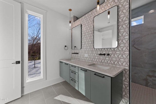 bathroom with tiled shower, vanity, tile patterned floors, and backsplash