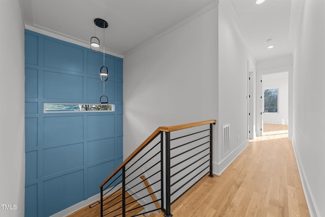 interior space with light hardwood / wood-style floors and ornamental molding