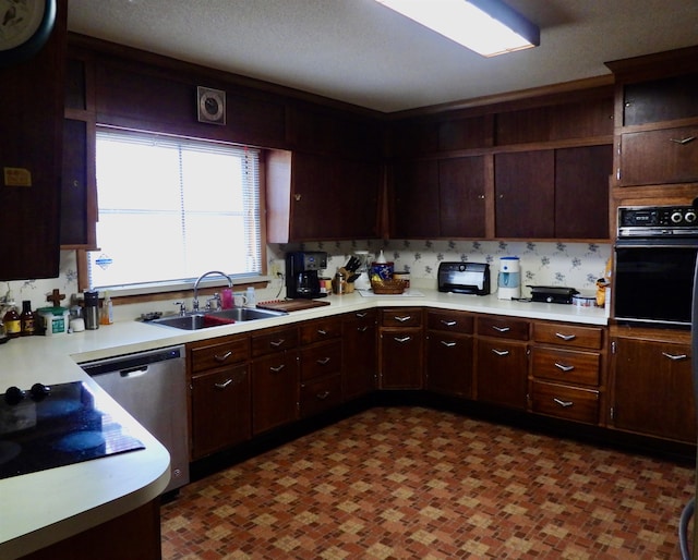 kitchen featuring sink, black oven, dark brown cabinetry, and stainless steel dishwasher