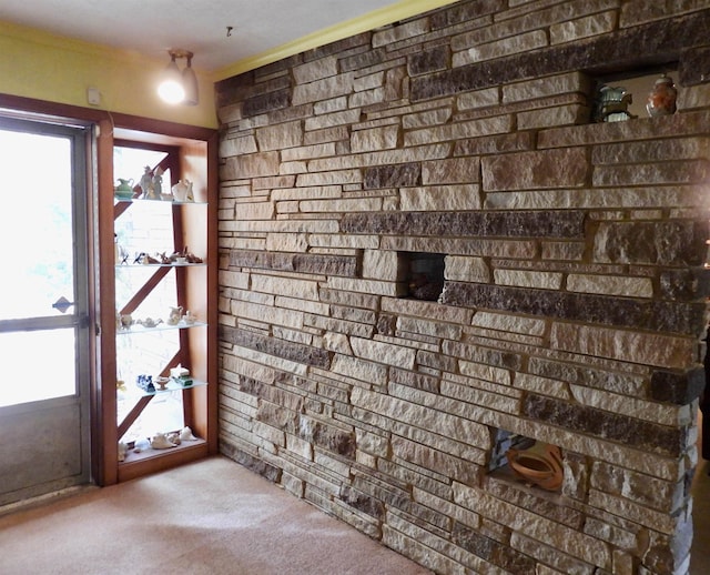 doorway to outside featuring carpet and plenty of natural light