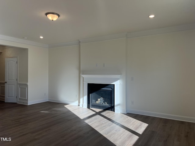 unfurnished living room with crown molding and dark wood-type flooring