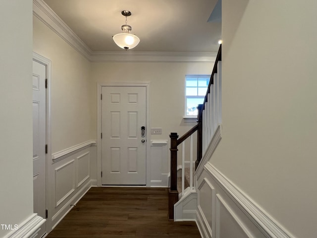 entrance foyer with dark hardwood / wood-style floors and ornamental molding