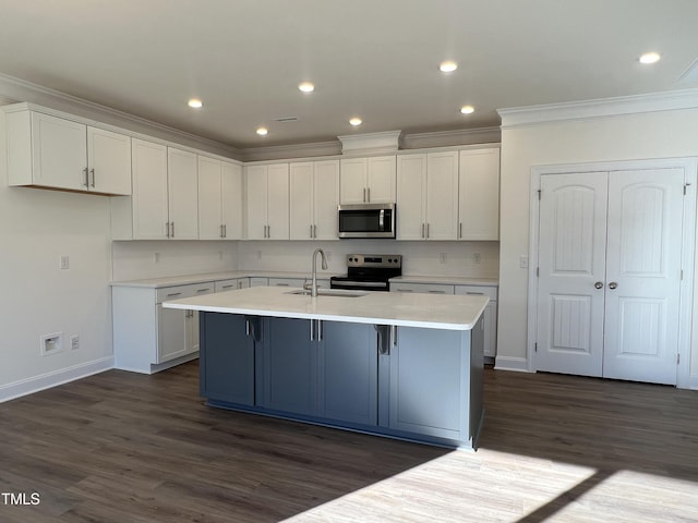 kitchen featuring dark hardwood / wood-style floors, white cabinetry, an island with sink, and appliances with stainless steel finishes