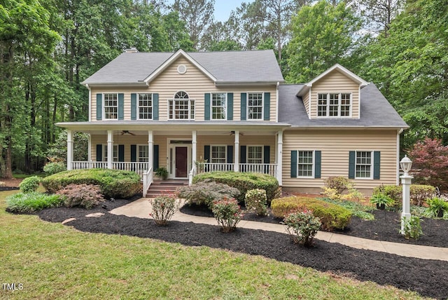 7811 Still Crossing Rd, Chapel Hill, NC 27516 - colonial inspired home with ceiling fan, covered porch, and a front lawn
