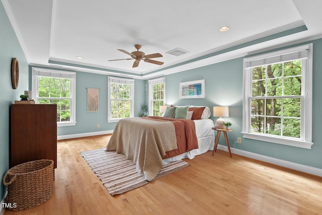 7811 Still Crossing Rd, Chapel Hill, NC 27516 - bedroom featuring a raised ceiling, crown molding, baseboards, light wood-style flooring, and ceiling fan