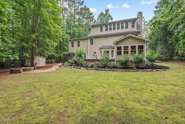 7811 Still Crossing Rd, Chapel Hill, NC 27516 - rear view of property with a sunroom, a chimney, a lawn, and a wooden deck