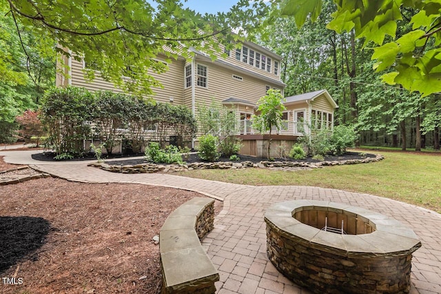 7811 Still Crossing Rd, Chapel Hill, NC 27516 - back of house featuring a fire pit, a wooden deck, a lawn, and a patio area