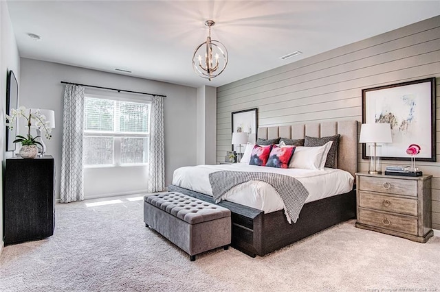 carpeted bedroom featuring a notable chandelier