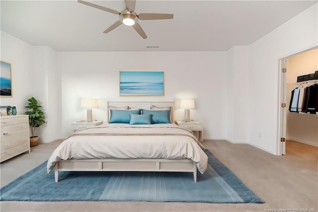 bedroom featuring ceiling fan and light carpet