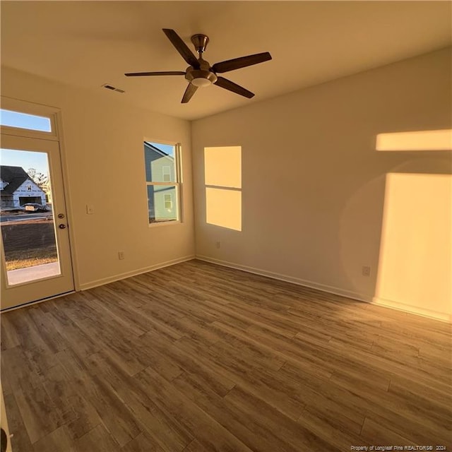 spare room with hardwood / wood-style flooring and ceiling fan