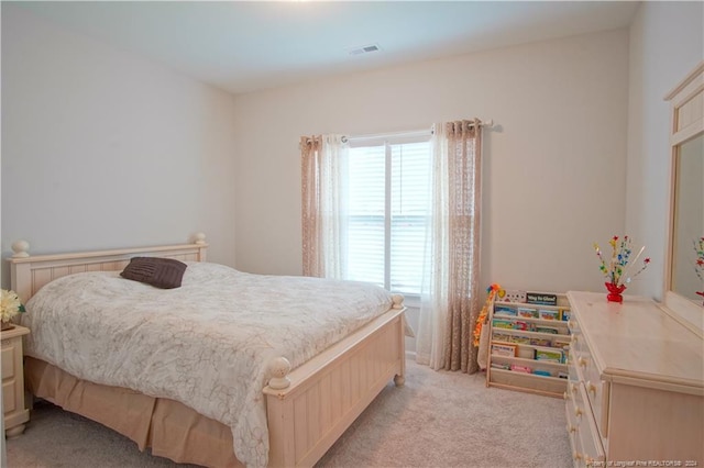 bedroom featuring light carpet