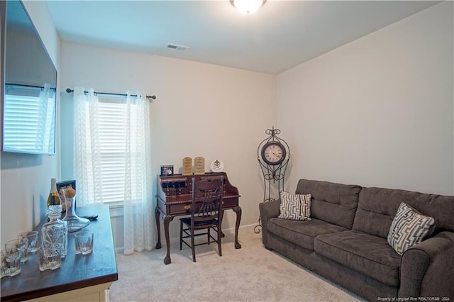 carpeted living room featuring healthy amount of natural light