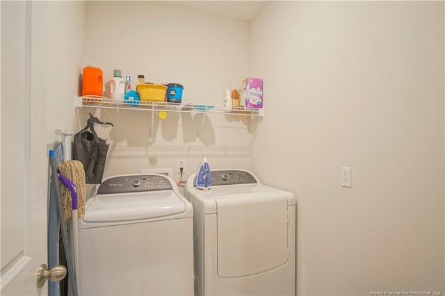 clothes washing area featuring washing machine and clothes dryer