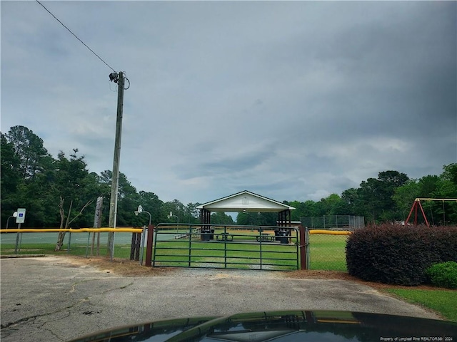 view of home's community featuring a gate and fence