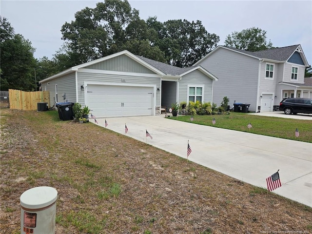 view of front of house with driveway, a garage, and central AC unit