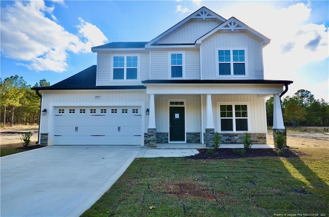 craftsman-style home with covered porch, a front yard, and a garage