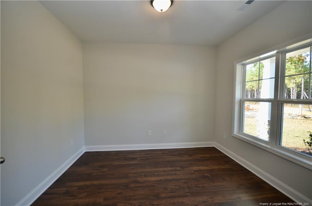 unfurnished room featuring dark wood-type flooring