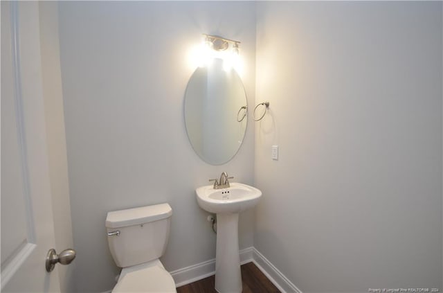 bathroom with sink, hardwood / wood-style floors, and toilet