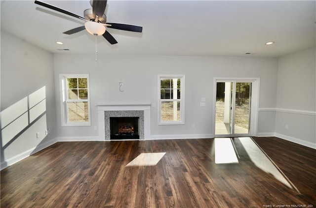 unfurnished living room featuring ceiling fan and dark hardwood / wood-style flooring