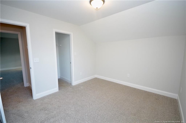 additional living space featuring light carpet and lofted ceiling