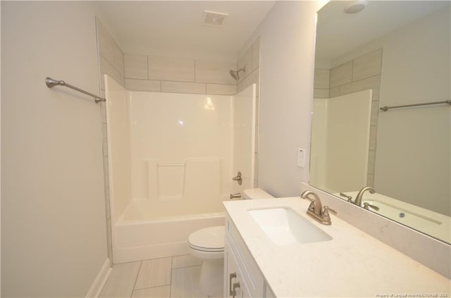 full bathroom featuring toilet, tiled shower / bath combo, vanity, and tile patterned floors