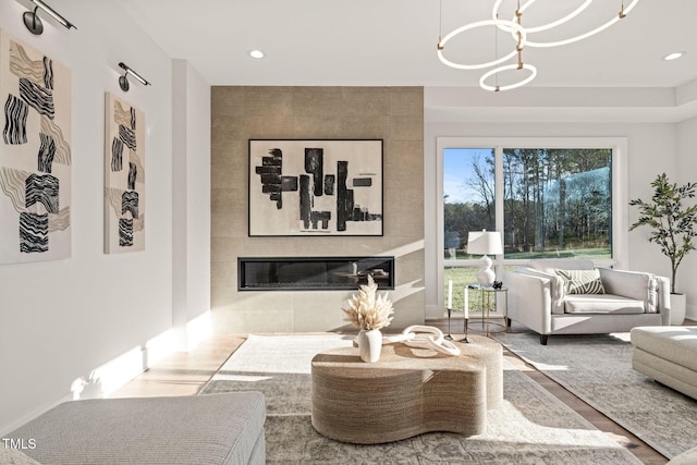 living room with hardwood / wood-style flooring and a tile fireplace