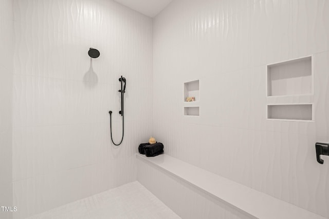 bathroom featuring tiled shower