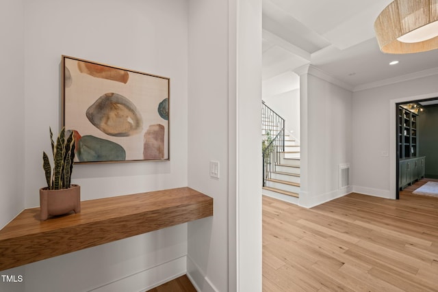 hall featuring crown molding and hardwood / wood-style floors