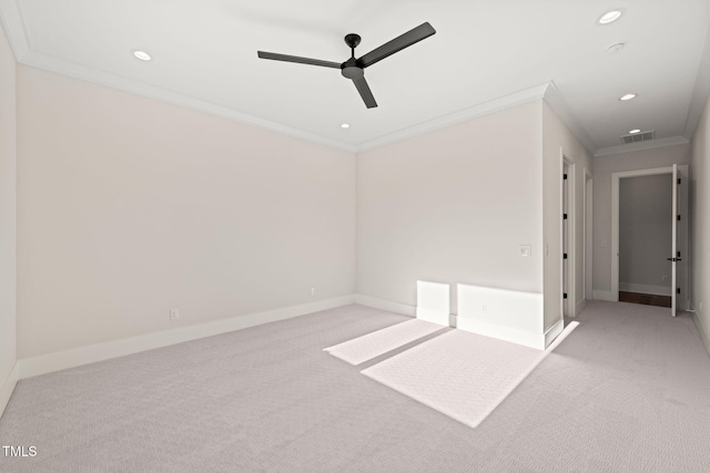 carpeted empty room with ceiling fan and ornamental molding