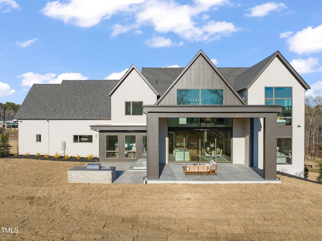 back of house with a yard, a fire pit, and a patio area