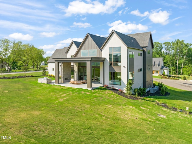 9009 Meadow Pointe Ct, Wake Forest, NC 27587 - back of property with a patio, a lawn, board and batten siding, and a shingled roof