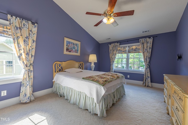 bedroom featuring lofted ceiling, light carpet, baseboards, and a ceiling fan