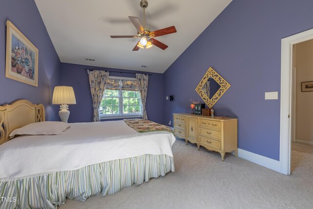 bedroom featuring light carpet, lofted ceiling, a ceiling fan, and baseboards