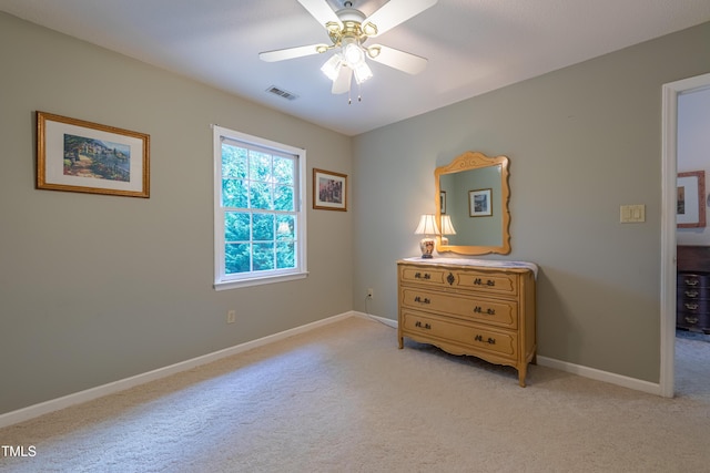 bedroom with light carpet, baseboards, and a ceiling fan