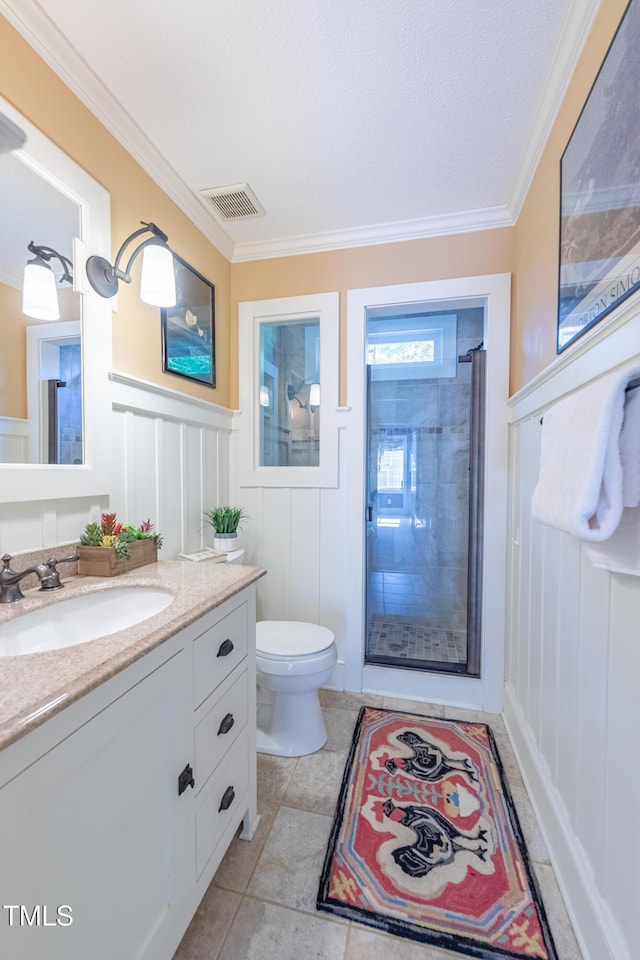 full bathroom featuring a decorative wall, ornamental molding, a shower, vanity, and toilet