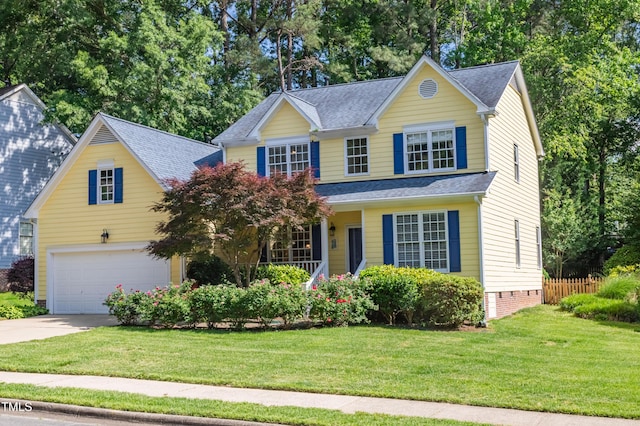 traditional-style house with driveway, an attached garage, a shingled roof, and covered porch