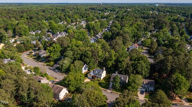 aerial overview of property's location featuring a heavily wooded area and nearby suburban area